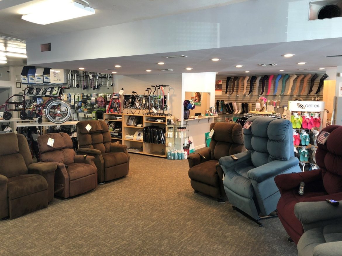 Photo of a Medical Equipment Showroom floor. Lift chairs are shown in the foreground with tons of other home medical supplies in the background.